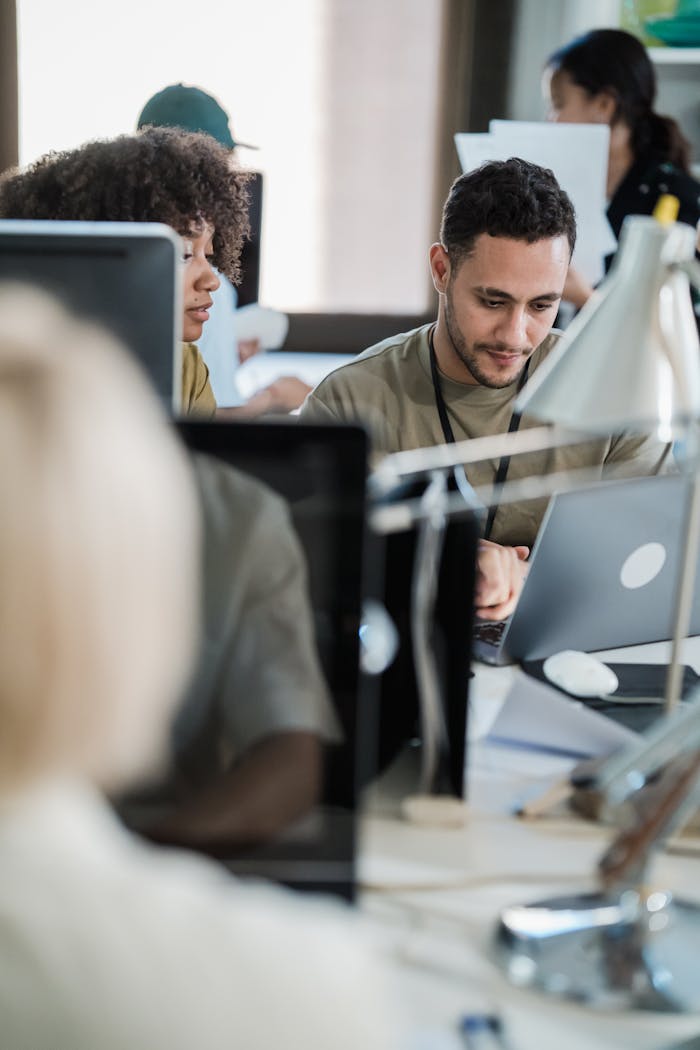 Diverse team collaborating on a project in a modern office setting. Perfect for business and teamwork themes.